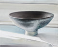 Oil painting of a footed grey-green bowl on a pale striped surface.